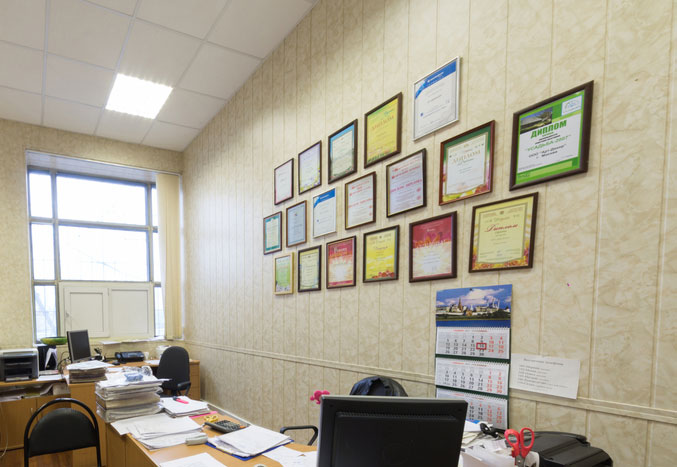 Certificates mounted on an office wall