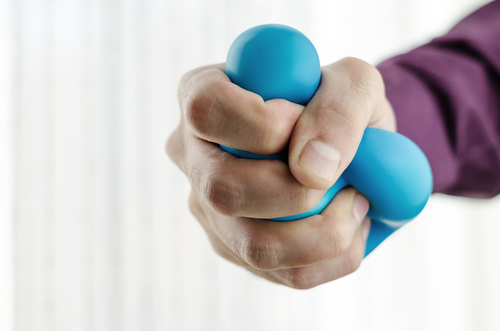 Hand crushing a stress ball